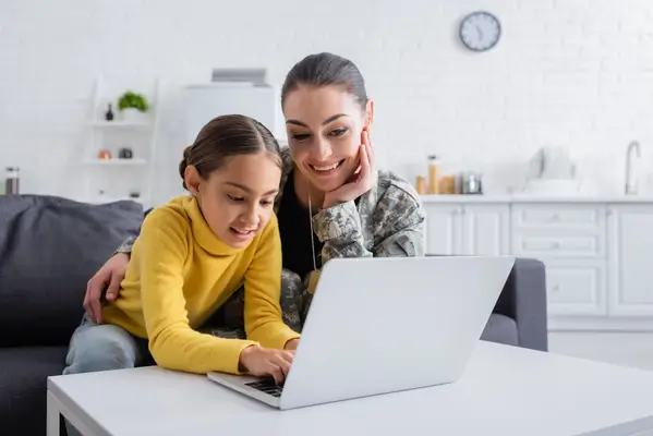 Mom and daughter looking at a laptop together